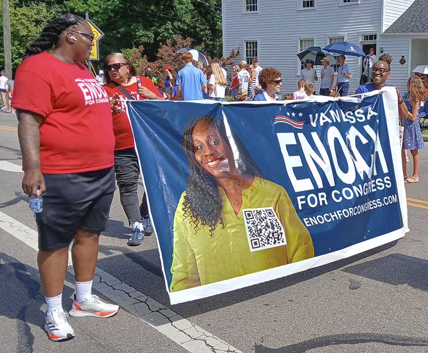 Enoch volunteers marching with Enoch banner