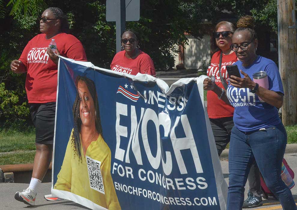 Enoch team marching with banner