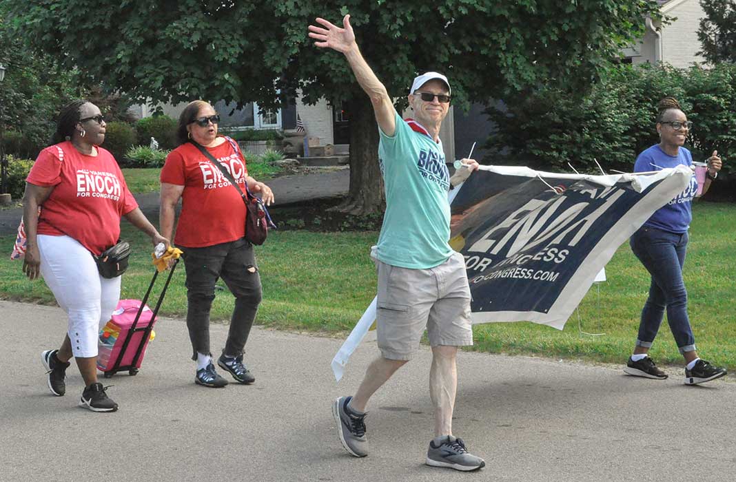 Vanessa Enoch and volunteers with banner