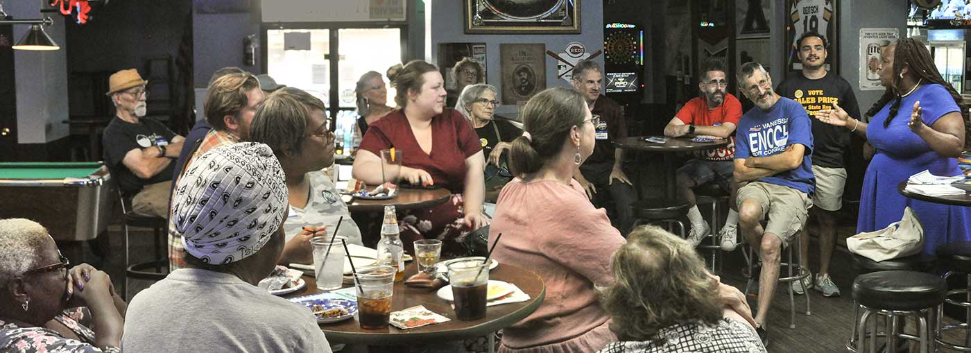 Dr. Vanessa Enoch speaking to a Democratic community group
